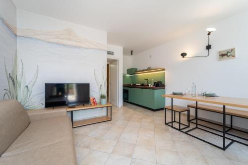 a living room with a couch and a flat screen tv at Elbitat Homes in Bagnaia
