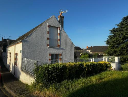a house with a windmill on the side of it at Maison de bord de Loire in Sully-sur-Loire