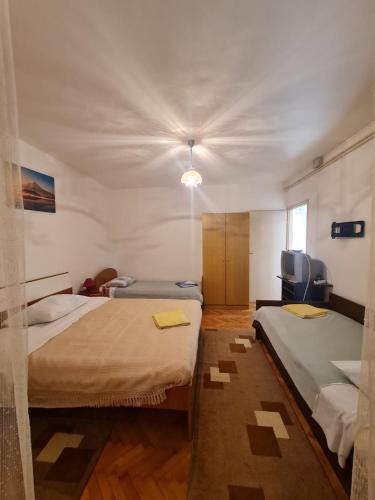 a room with two beds in a room at Apartment Ivan in Sukošan