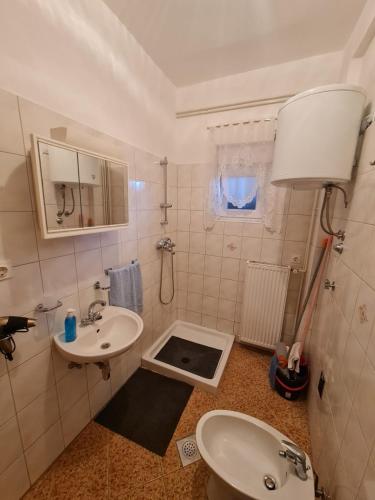 a small bathroom with a sink and a toilet at Apartment Ivan in Sukošan