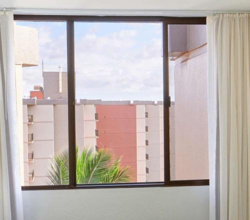 a window with a view of a building at Aston Kaanapali Shores in Lahaina