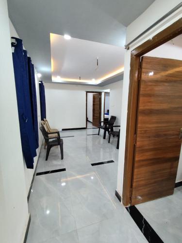 a room with a door and chairs and a board at rest n' refresh in Visakhapatnam