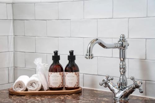 two bottles of wine on a cutting board next to a sink at Brunfels Hotel, in the Unbound Collection by Hyatt in Mainz