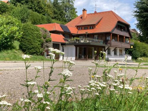 a large house with an orange roof at Gästehaus Sonnenheim, Friedenweiler, Titisee in Friedenweiler