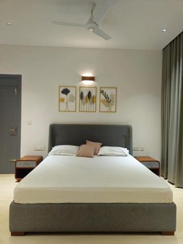 a bedroom with a large bed in a room at Ocean Whisper- psst! hidden gem in Kaipamangalam