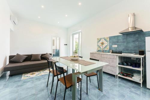 eine Küche und ein Wohnzimmer mit Tisch und Stühlen in der Unterkunft Il Poeta nella Vigna in Procida