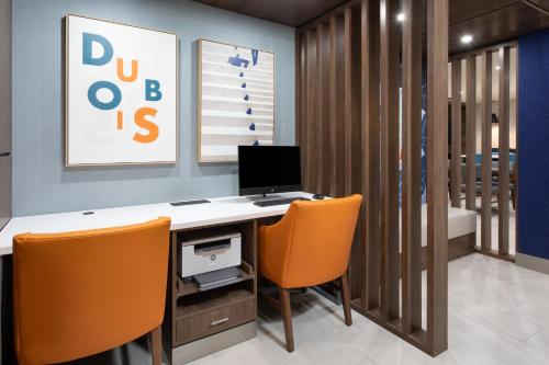 an office with a desk with a computer and orange chairs at Holiday Inn Express Hotel & Suites Dubois by IHG in DuBois