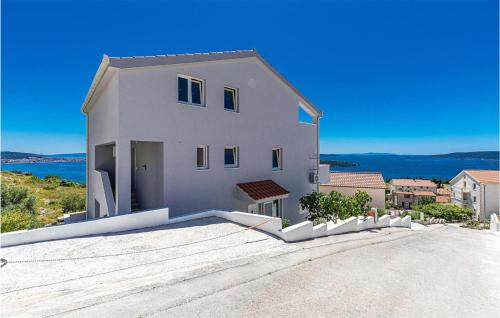 a large white house with a view of the ocean at Beautiful Apartment In Seget Donji in Seget Donji