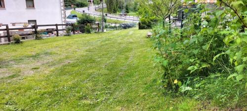 a field of grass with a fence and a path at Maison du Soleil- CIR VDA Valtournenche n 0204 in Valtournenche
