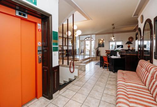 a restaurant with orange walls and a waiting room at Schlosshotel Marienbad in Mariánské Lázně