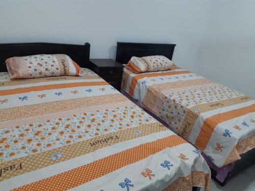 two beds sitting next to each other in a room at الغردقة الدهار القيادات in Hurghada