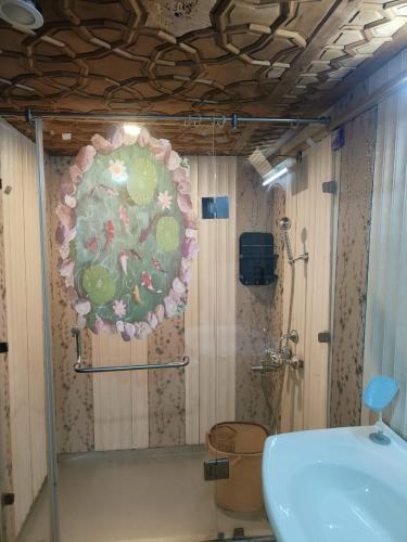 a bathroom with a shower with a toilet and a mirror at Houseboat New Suzan in Srinagar