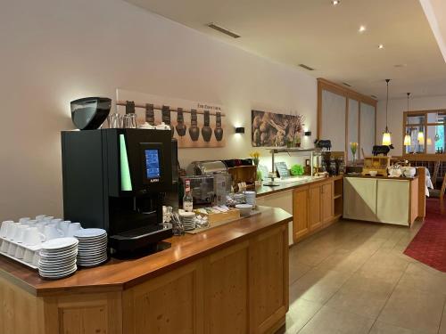 a kitchen with a counter with dishes on it at Hotel Feldwebel in Söll