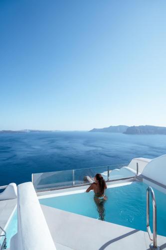 a woman in a swimming pool on a boat at Elite Luxury Suites in Oia