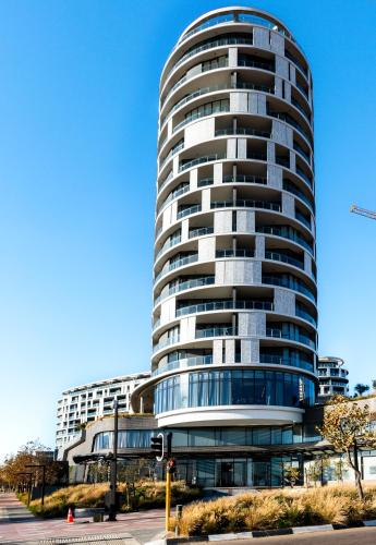 a tall building with a lot of windows at Ellipse Waterfall Luxury Apartments in Midrand