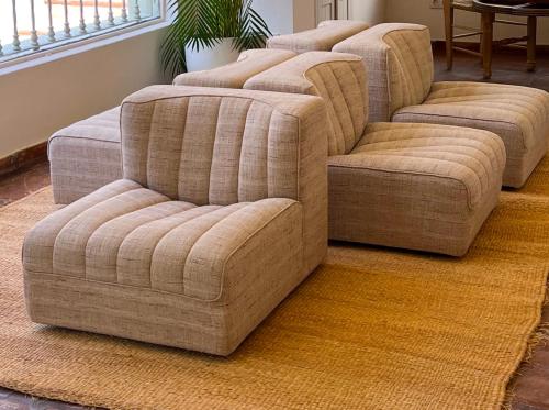 four chairs and a couch in a living room at MalaQuita Hotel Boutique in Santa Eularia des Riu