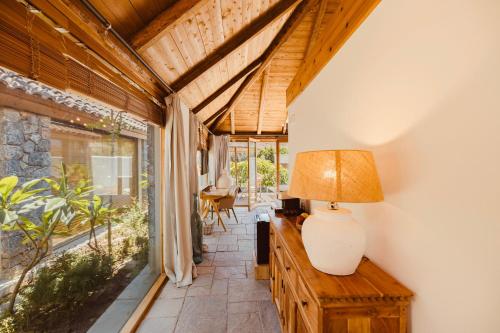 a room with a table with a lamp on top of it at Caesars Gardens Hotel & Spa - Adults Only in Líndos