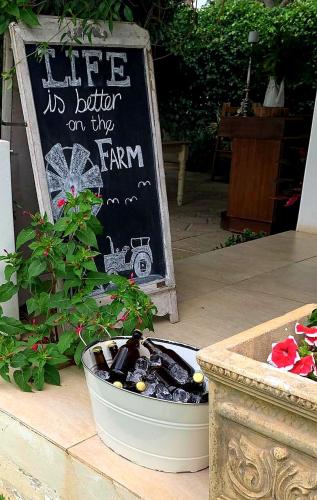 a sign that says life is better on the farm at Avoca River Cabins in Addo