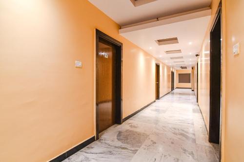 a corridor of an office with orange walls at FabHotel Shivani International in Rānchī