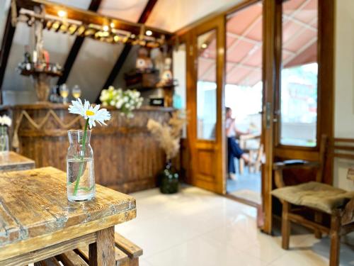 a vase with a flower in it sitting on a table at Betlemi Old Town Hotel in Tbilisi City