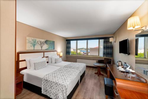 a hotel room with a bed and a desk at Istanbul Golden City Hotel in Istanbul