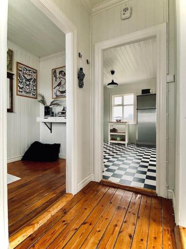 a kitchen with a checkered floor in a room at Seaside Retreat, Glacier View in Hellissandur