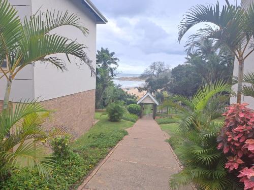 a sidewalk leading to a building with a gazebo at Ramsgate Palms 57 in Ramsgate