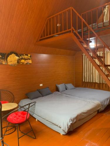 a bed in a room with a staircase at Chú Thiện Homestay and Camping in Sóc Sơn