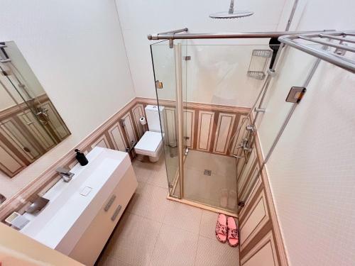 a bathroom with a shower and a sink and a toilet at Park Azure 0313 in Baku