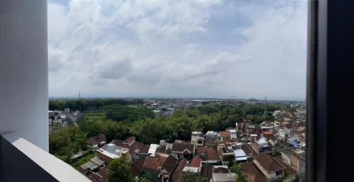 a view of a city with houses and trees at Levi Begawan Apartment in Blimbing