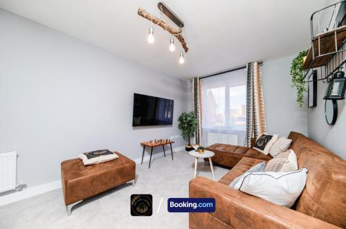a living room with a couch and a table at Manchester 3-Bed House l Free Parking l WiFi l Your Home Away From Home hosted by The Cosy Corner Nationwide in Manchester