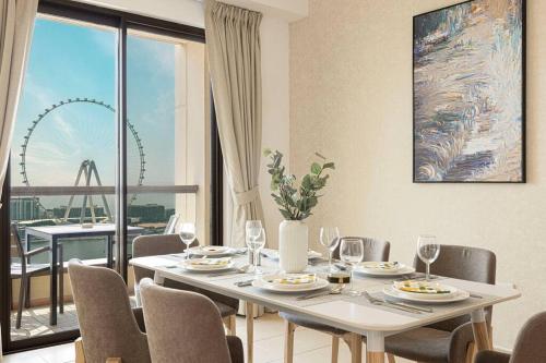 a dining room with a table and a large window at Dubai Eye & Sea View, 1-min walk to JBR Beach, Luxurious Beach Retreat! in Dubai