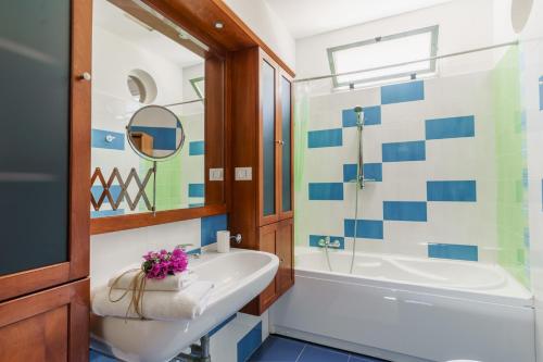 a bathroom with a tub and a sink at La maison de Rosetta al mare in Specchiolla 