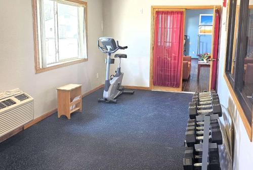 a room with a gym with a treadmill and a table at Days Inn by Wyndham North Sioux City in North Sioux City