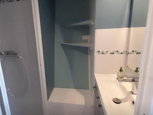 une salle de bain blanche avec un lavabo et une douche dans l'établissement Charmant T2 proche océan avec terrasse, wifi et parking privé - Vieux-Boucau, 4/5 pers. - FR-1-379-132, à Vieux-Boucau-les-Bains