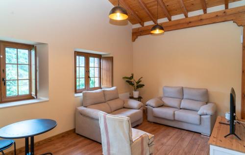 a living room with a couch and a table at La Casita Verde de Cabárceno in Sobarzo
