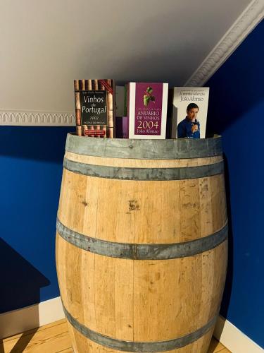 a wooden barrel with books on top of it at Casa do Vinho Sintra Guest House in Sintra