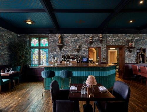 a bar in a restaurant with tables and chairs at Old Bell Hotel in Malmesbury