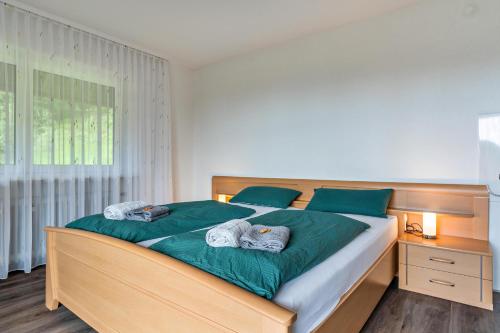 a bedroom with a large bed with two towels on it at Fuchsmichelhof 4 in Seebach
