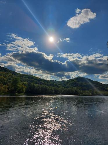 a view of a river with the sun in the sky at Vila Vitezov Mir - Drina in Vrhpolje