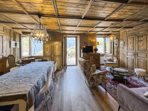 a dining room with a large table in a room at Swiss Alpine Retreat & View near Martigny in Salvan