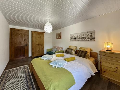 a bedroom with a large bed and a couch at Swiss Alpine Retreat & View near Martigny in Salvan