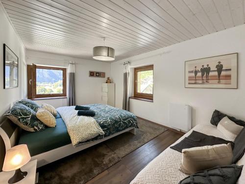 a bedroom with a bed and a couch at Swiss Alpine Retreat & View near Martigny in Salvan