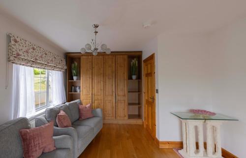 a living room with a couch and a table at Mountain Nest at the foot of Slieve Gullion in Cloghoge