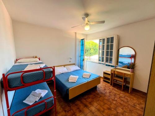 a bedroom with two bunk beds and a mirror at Dipendenza BeB Villa Denny in Rimini