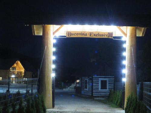 a sign for the brooklyn exhibit at night at Bucovina Exclusiv in Vama