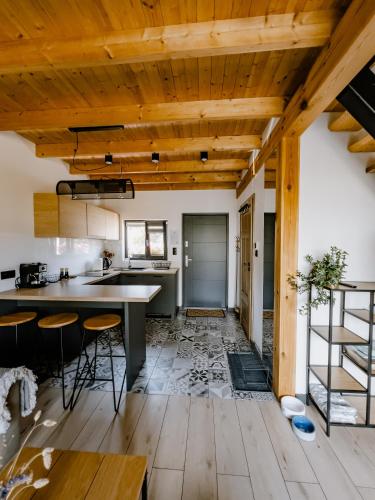 a kitchen with wooden ceilings and a table and chairs at Dobre Kąty całoroczne domki in Kąty Rybackie