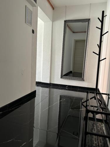 a mirror on a wall next to a room at Prenoćište Šimić in Slavonski Brod