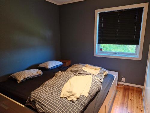 a bedroom with two beds and a window at Beautiful Villa with amazing view in Bergen. in Bergen