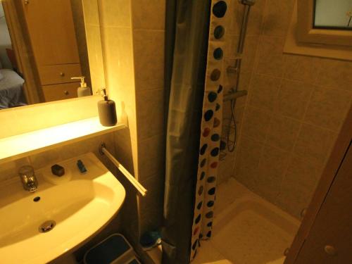 a bathroom with a shower curtain and a sink at Appartement T3 50m² pour 4 pers. avec Wifi et animaux admis à Luchon - FR-1-313-205 in Luchon